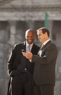 Businessmen looking at cell phone