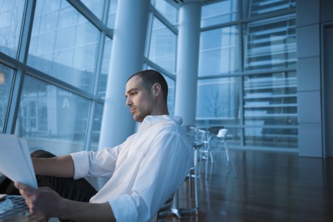 Caucasian businessman looking at paperwork