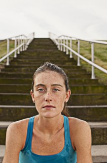 Serious Caucasian woman sitting on steps