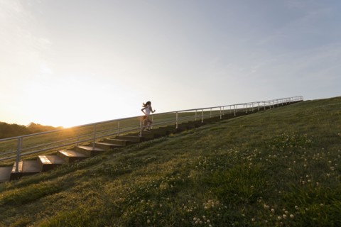 Caucasian woman running up steps