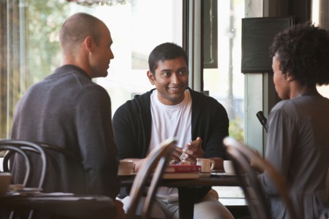 Friends sitting together in cafe