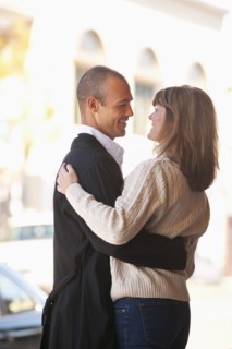 Caucasian couple hugging outdoors