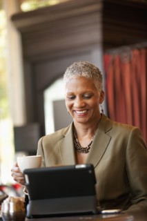 African American businesswoman using digital tablet in cafe