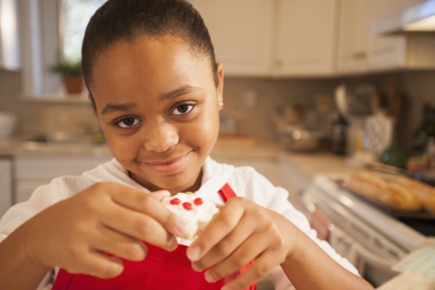 African American girl baking in kitchen