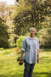 Mixed race woman gardening outdoors