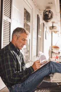 Caucasian businessman working on patio