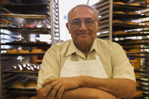 Hispanic baker working in commercial kitchen