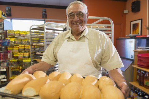 Hispanic baker working in commercial kitchen