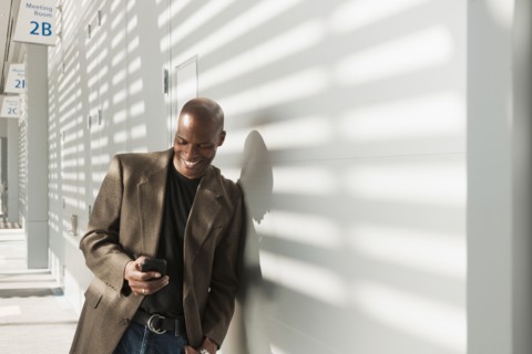 African American businessman using cell phone in office