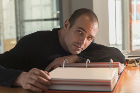Caucasian businessman reading at desk