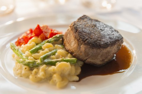 Plate of seared meat with vegetables and pasta