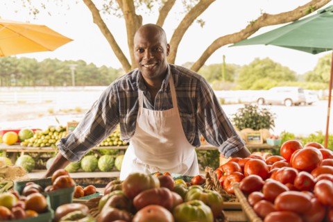 African American vendor smiling at farmers market