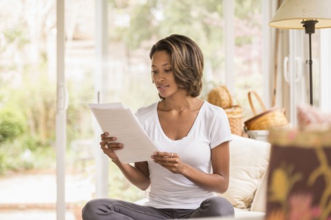 African American woman reading paperwork