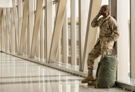 African American soldier talking on cell phone in airport