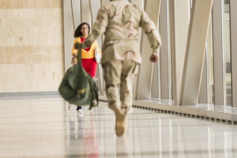 African American soldier greeting wife in airport
