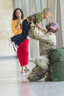 African American soldier greeting family in airport