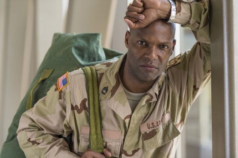 African American soldier carrying duffel bag