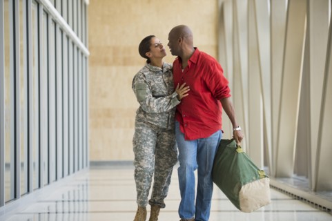 African American soldier talking to husband in airport