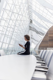 Black businesswoman using cell phone in conference room
