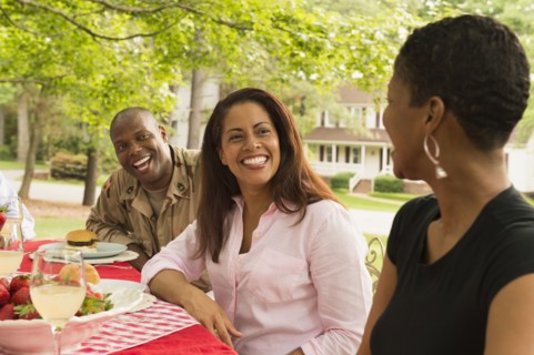 African American man and women laughing at picnic