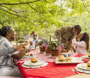 Soldier man kissing wife at picnic