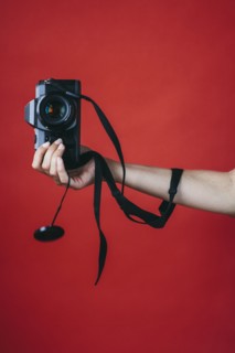 Hand of woman holding camera
