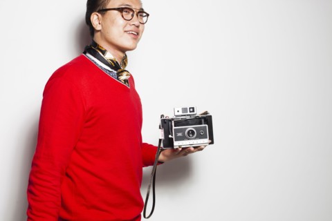 Asian photographer holding vintage camera
