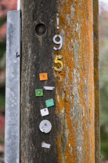 Metal numbers nailed to pole