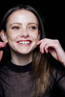 Smiling Caucasian woman pinching cheek