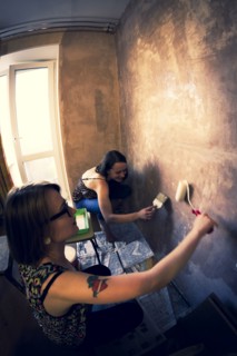 Women painting wall