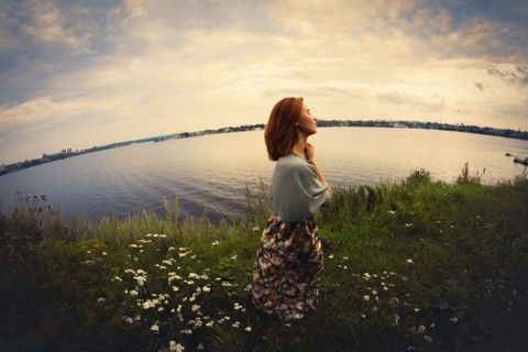 Caucasian woman walking near lake