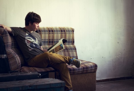 Caucasian man reading in living room