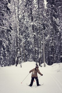 Caucasian girl cross-country skiing in forest