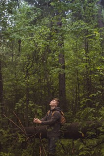 Caucasian man walking in forest