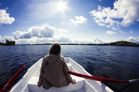 Caucasian woman sitting in rowboat