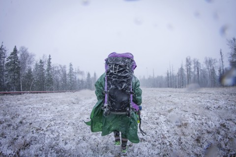Caucasian hiker standing in frosty field
