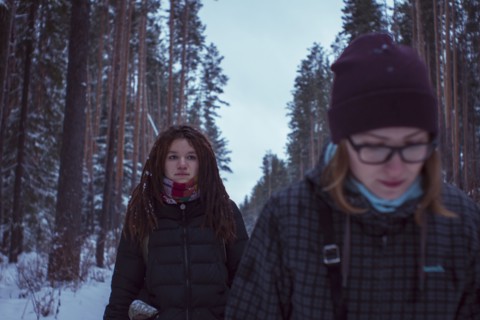 Caucasian women walking in snowy forest