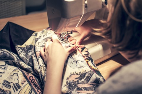 Caucasian woman using sewing machine