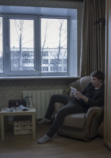 Caucasian man reading digital tablet in living room