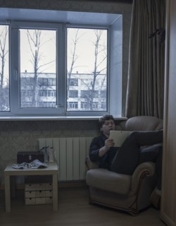 Caucasian man reading digital tablet in living room