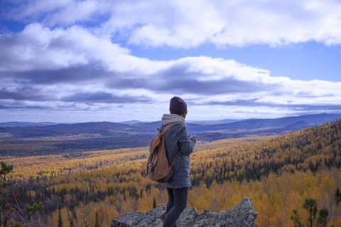Caucasian woman backpacking in autumn landscape