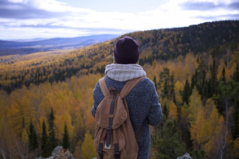 Caucasian woman backpacking in autumn landscape