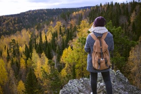 Caucasian woman backpacking in autumn landscape