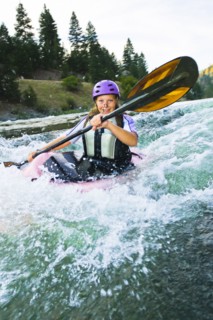 Caucasian teenager kayaking in river