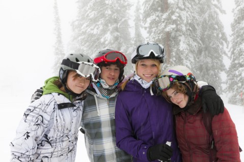 Skiers standing in snow