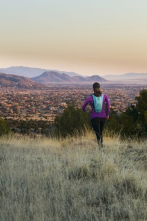 Hispanic woman running in remote area