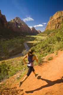 Persian woman running in canyon