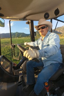 Hispanic man driving tractor