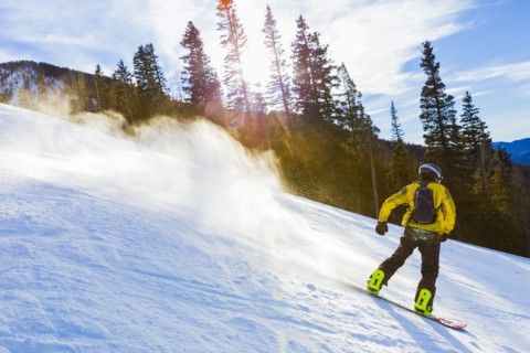 Caucasian teenager snowboarding