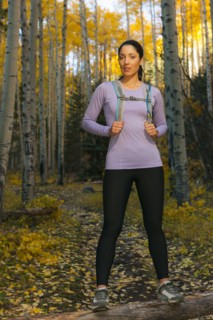 Hispanic woman hiking in woods
